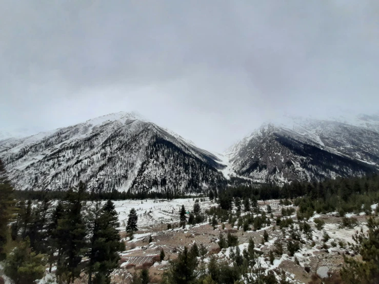 two snowy mountains are seen from a distance