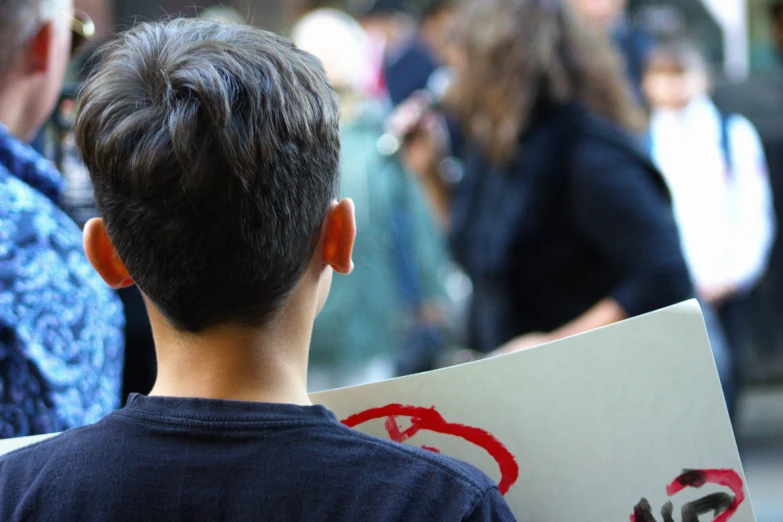 a  holding a piece of paper with writing on it