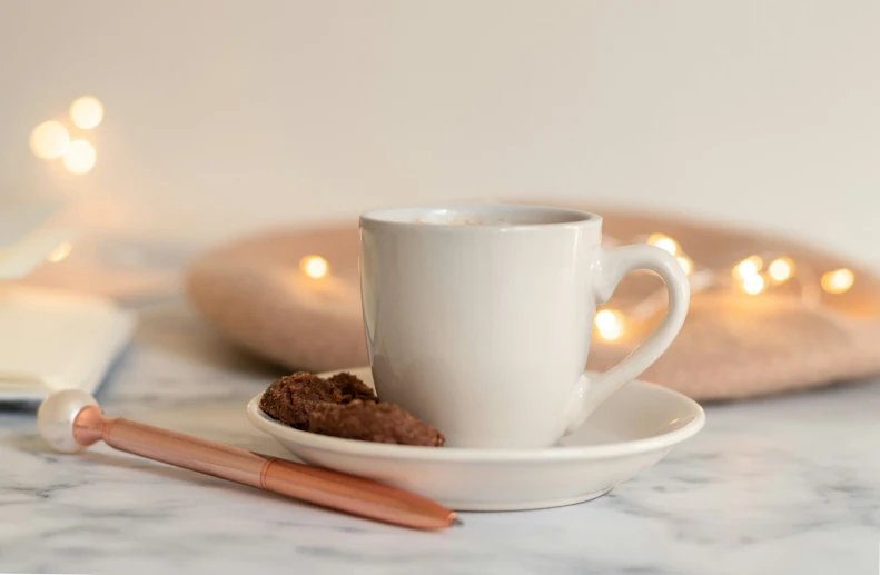 a cup of coffee with a saucer in the background