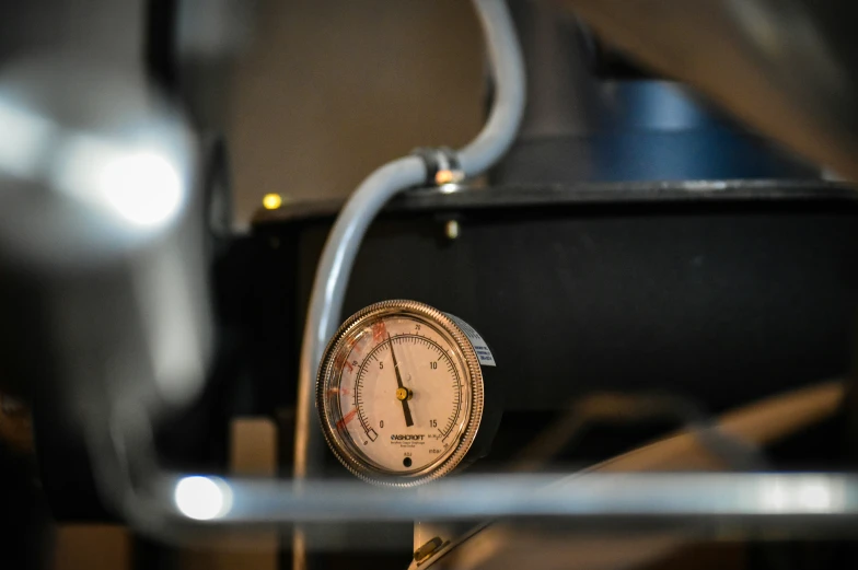 a close up of a pressure gauge attached to a stand