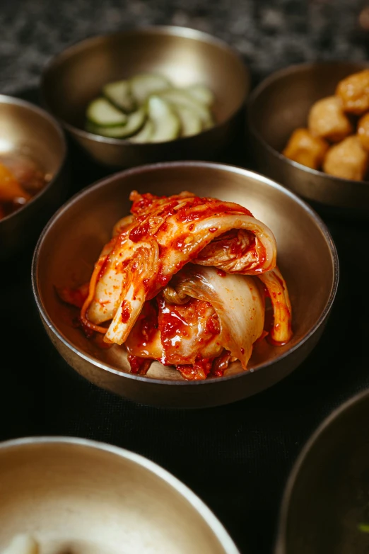 the dishes are served in individual metal bowls