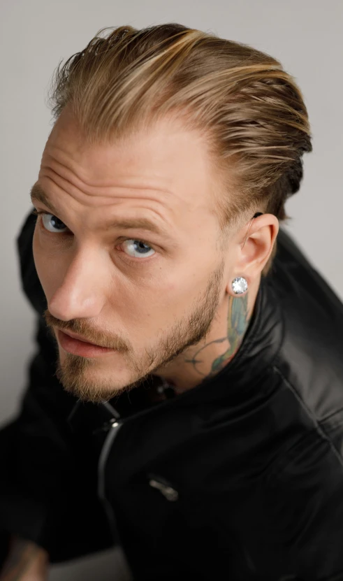 man with piercings in a black jacket and leather jacket