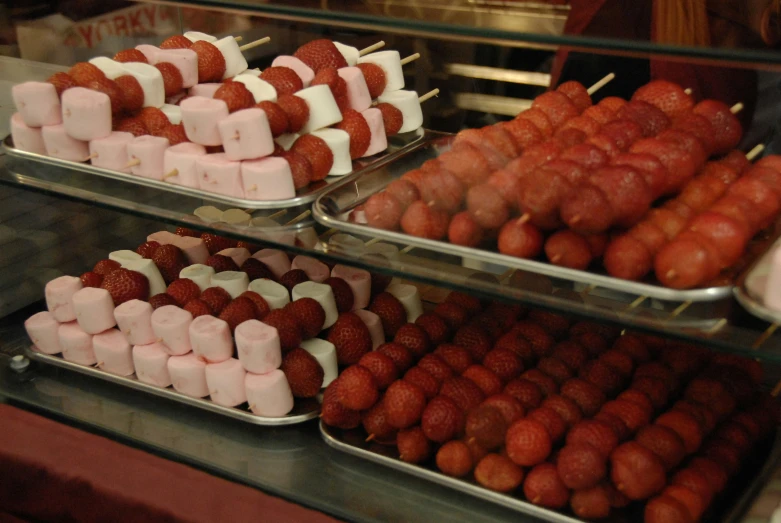 trays of food are shown with marshmallows on the side