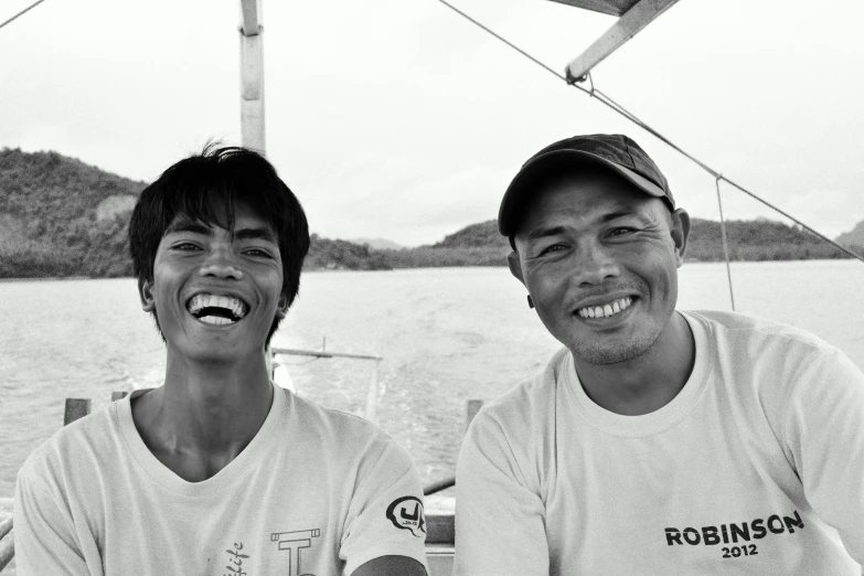 two young men are smiling at the camera