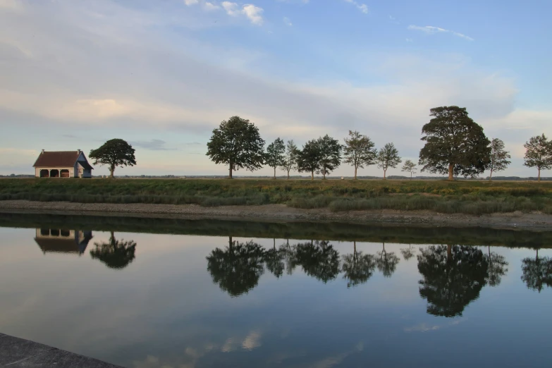 a house is seen sitting near the water