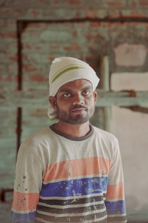 a man in a colorful shirt is wearing a hat