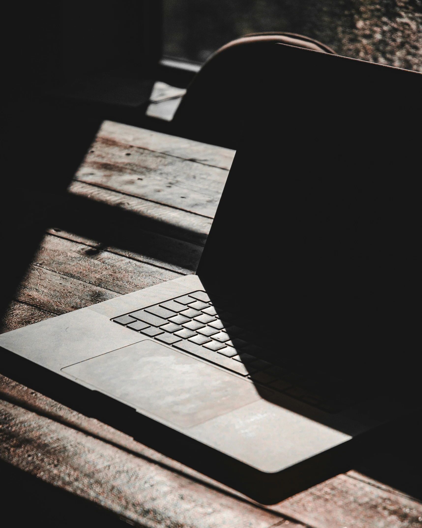 a laptop is shown on the table in the dark