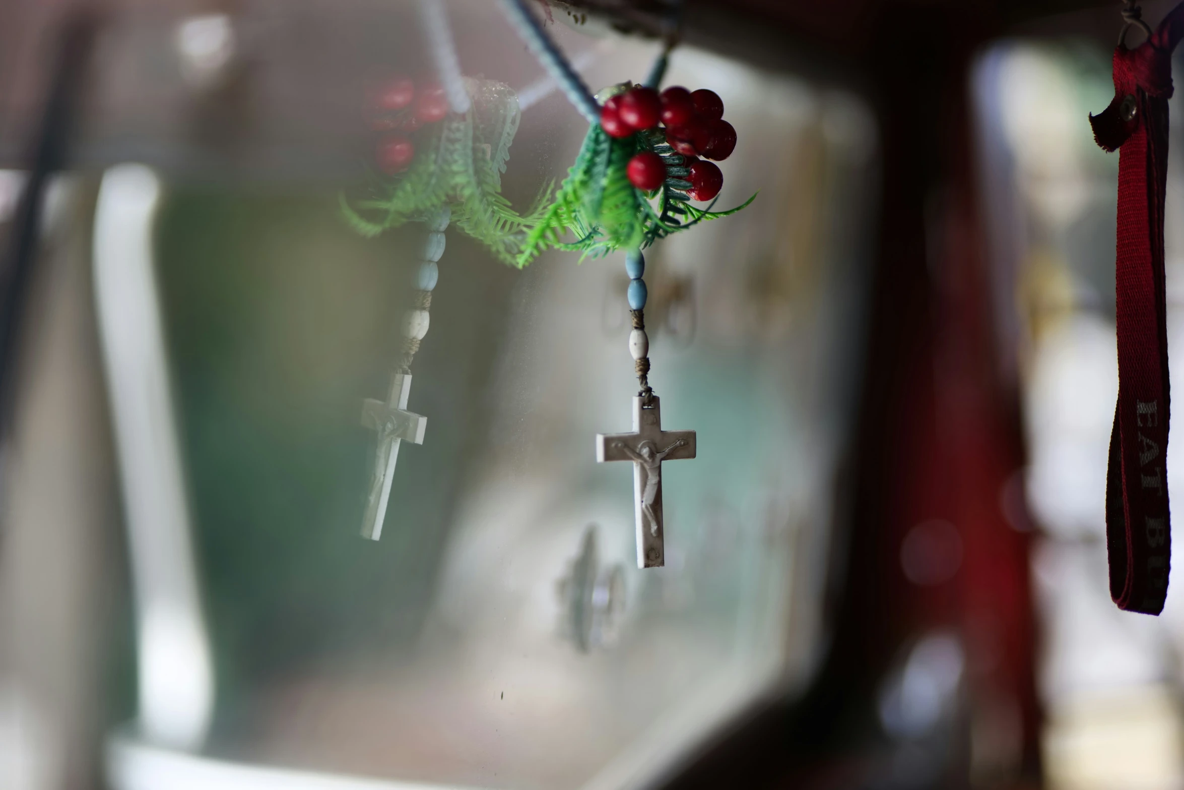 two crosses hanging from the side of a wall