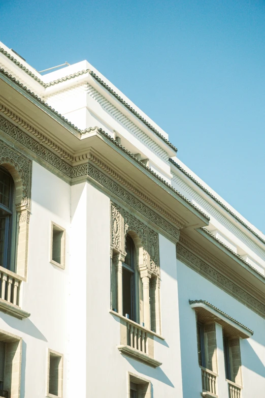 the top of a building with shutters on each of it's windows