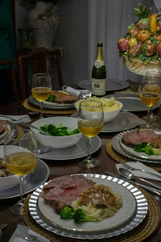 a table with plates of food and a wine glass on it