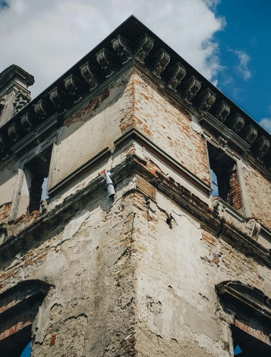 an old building against the sky with old windows