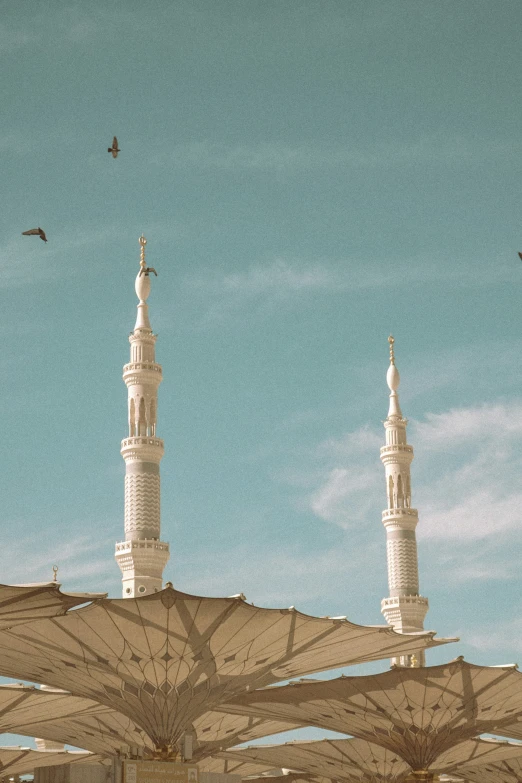 two large white towers are above a blue sky