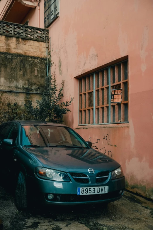 a car parked on the street next to some windows