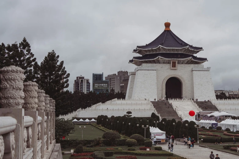 an asian styled white and grey building with red accents