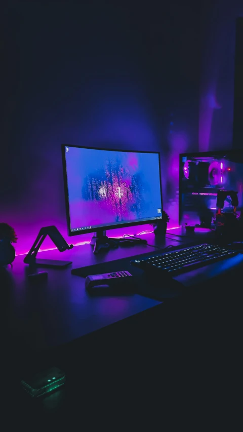 the lights on the computer desk are purple