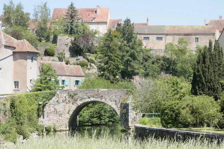 a stone bridge leads across to an old village