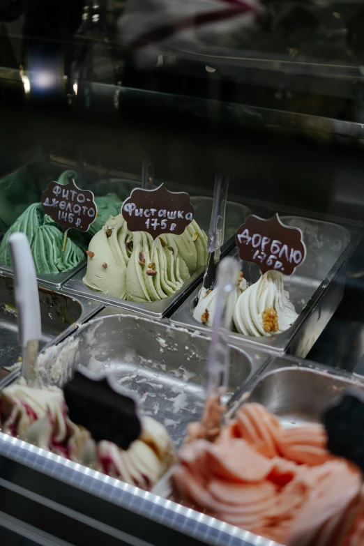 several varieties of different ice creams in a display case