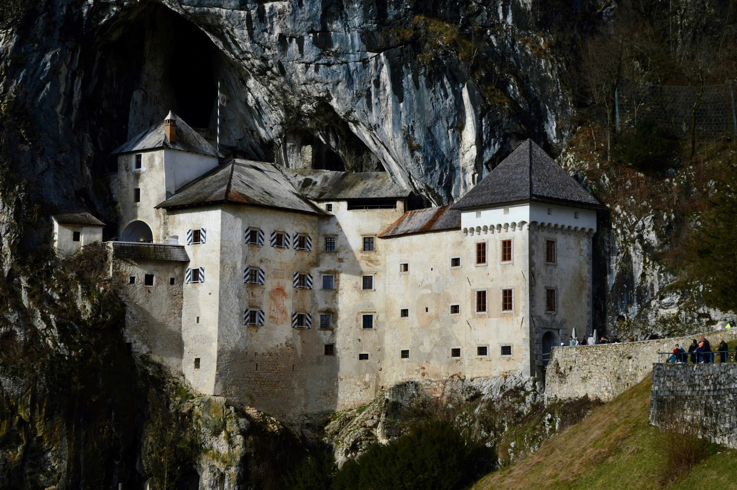 a very tall building on top of a rocky hillside