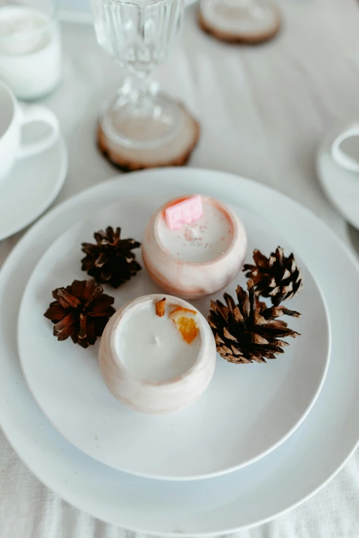 small cookies and an orange sit on a white plate