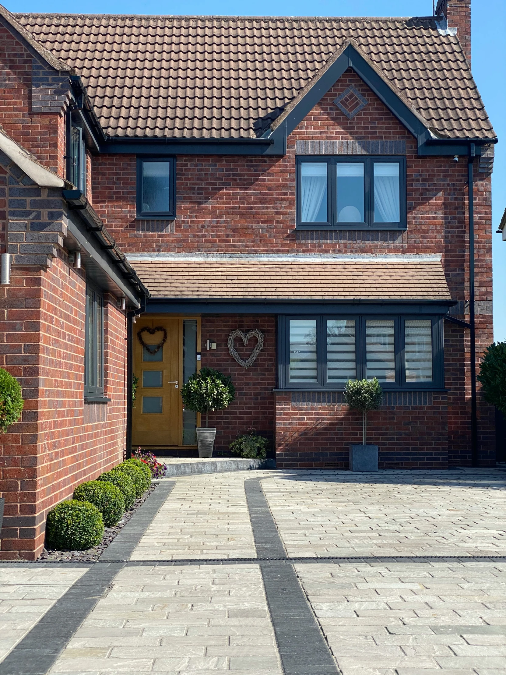 a brick house has a double door and two windows