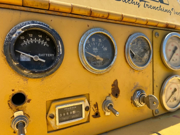 a large yellow machine with several gauges on it