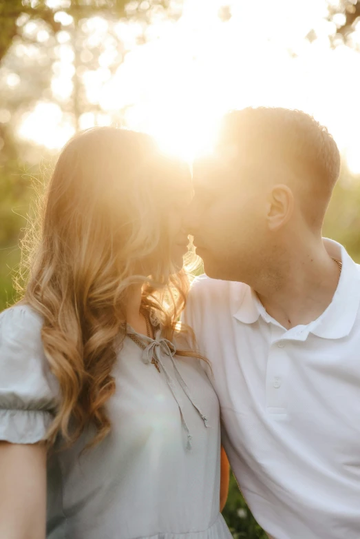 an image of a couple kissing in the sun