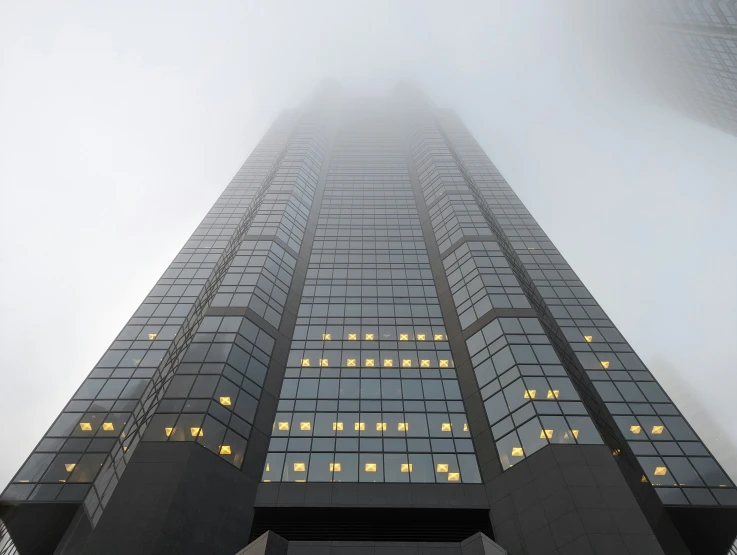 fog enveloping the top of a skyscr building