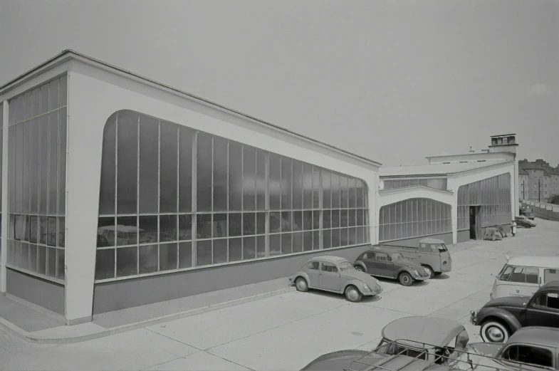 an image of a vintage po of cars parked in front of a building