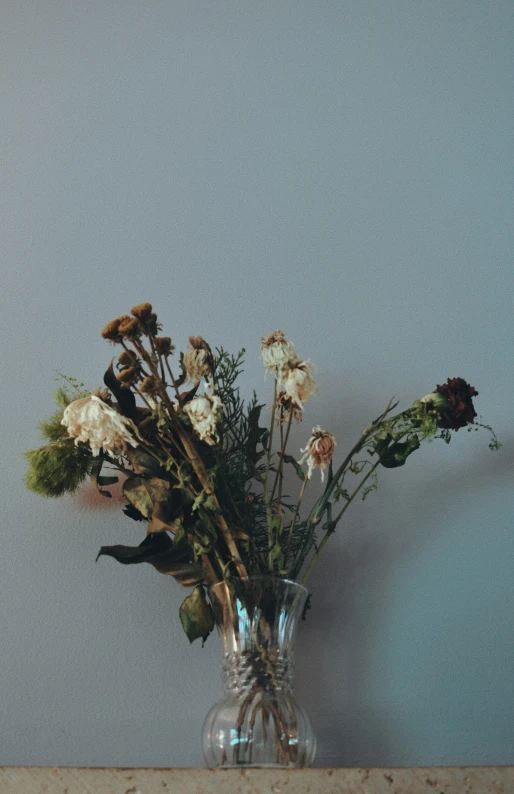 an arrangement of white flowers is in a vase