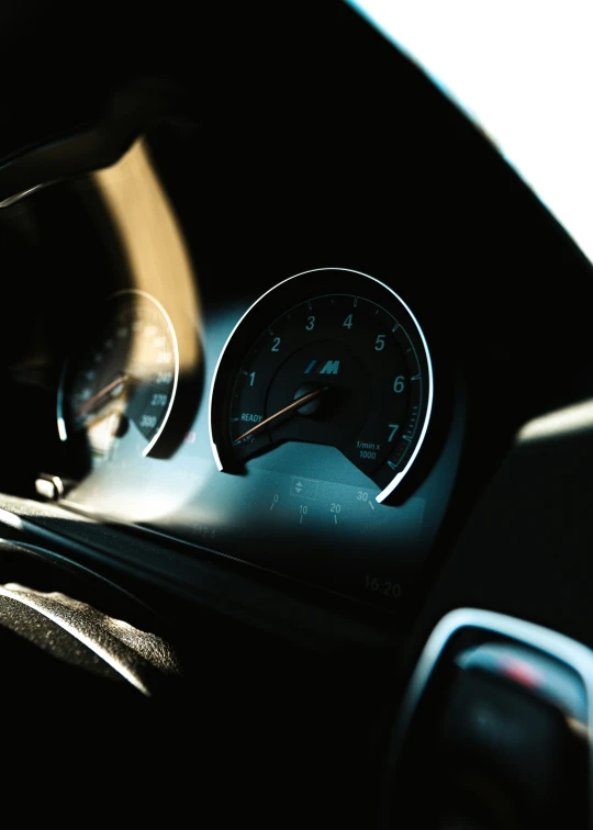 a car dashboard is shown with the speed gauges and other instruments