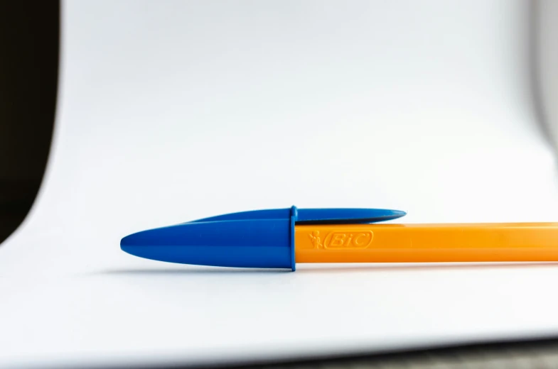 a pen resting on top of a desk in front of a monitor