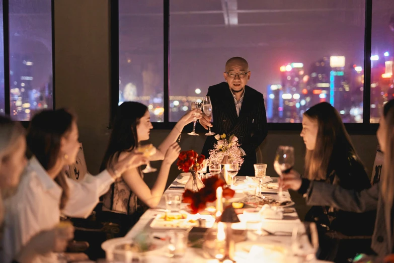 people sitting at tables in a dining room eating and drinking