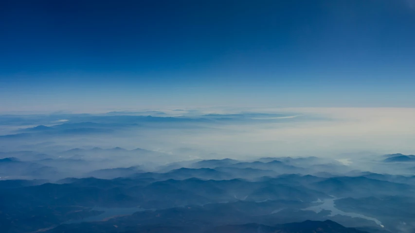 some mountain top with a blue sky and white clouds