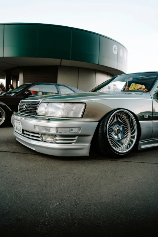 a very nice looking car parked by some big shiny tires