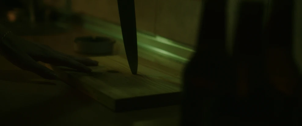 some sharp scissors are being held by someone in the dark