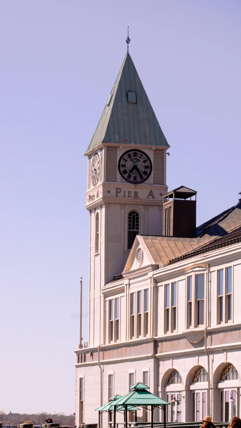 a tall tower clock next to a building