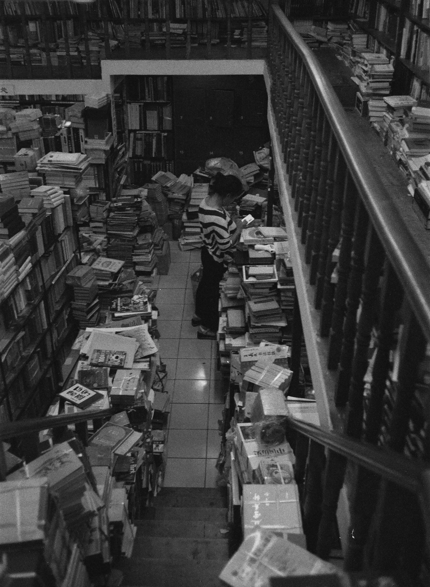 many large boxes and many small books in a large warehouse