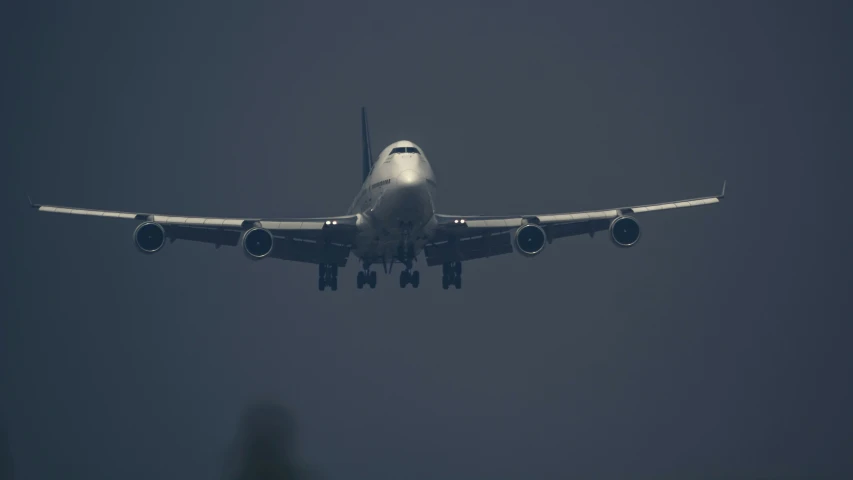 an airplane with two engines is flying overhead