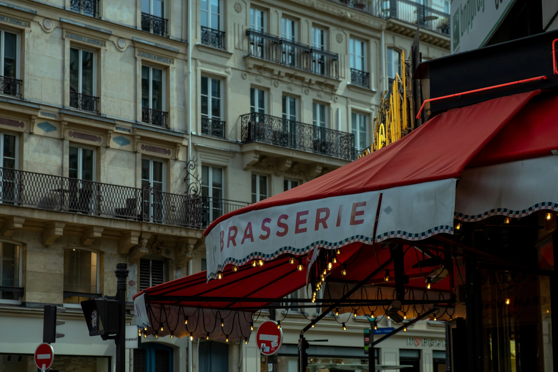 a store has a red awning that says rasserie