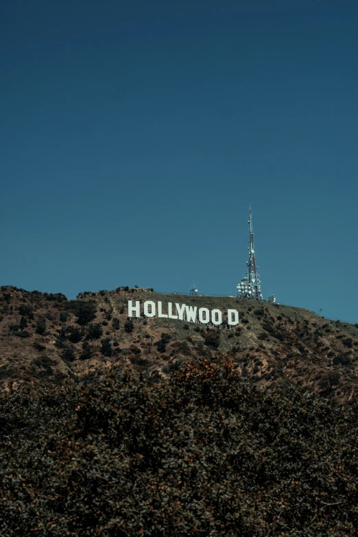 a building with a television tower and a sign for hollywood