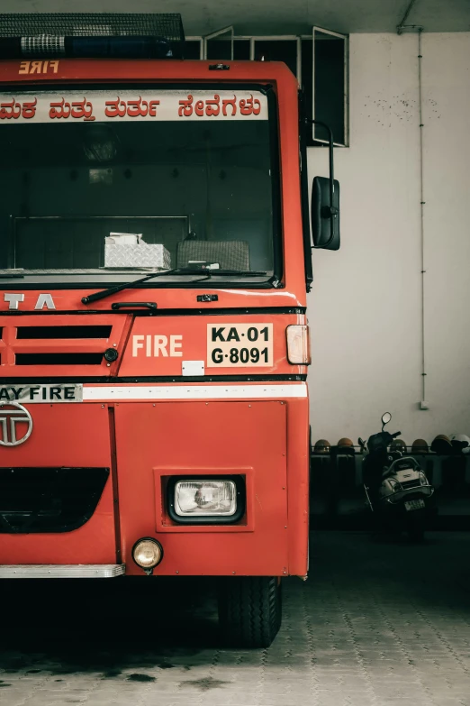 an orange fire truck is parked in a garage