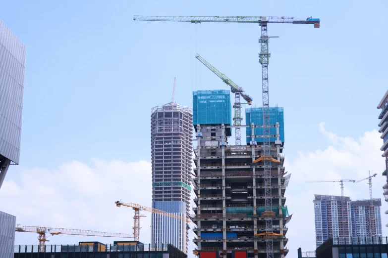 a very tall building under construction with cranes