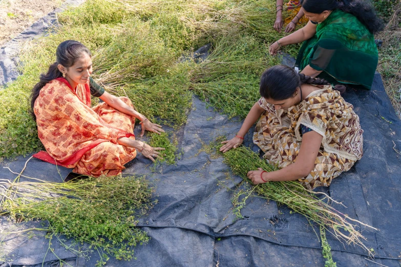 a group of women sitting on the ground