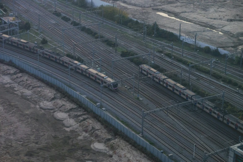 aerial view of railroad tracks in area with trees