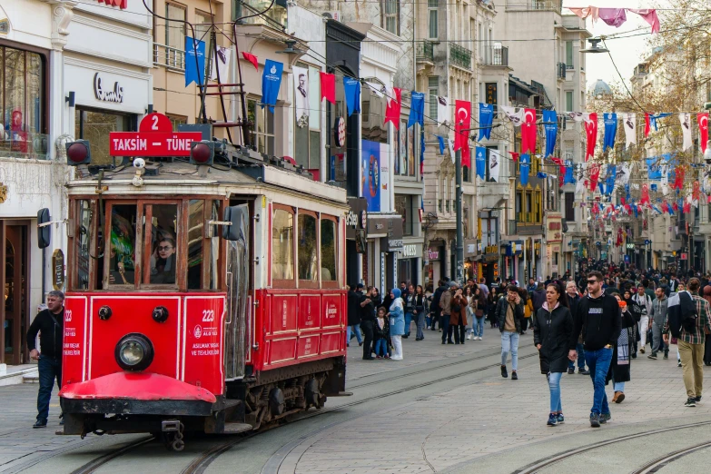 people walk near a trolley in an urban area