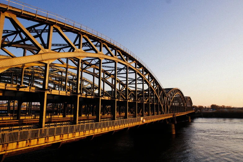 bridge on top of the river with sun reflecting off it