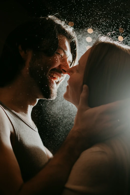 a couple smiling together in front of a mirror