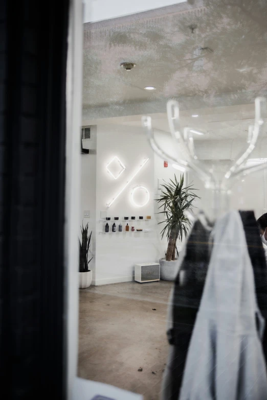 a man walking through a window in front of a light