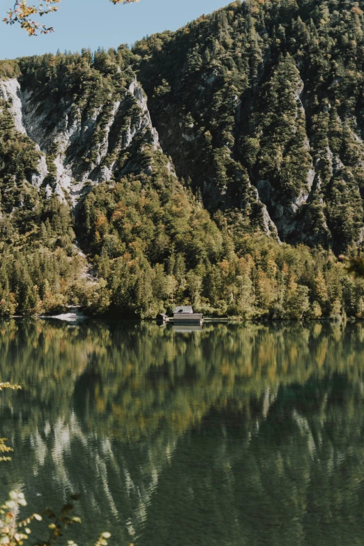 a body of water surrounded by mountains and trees