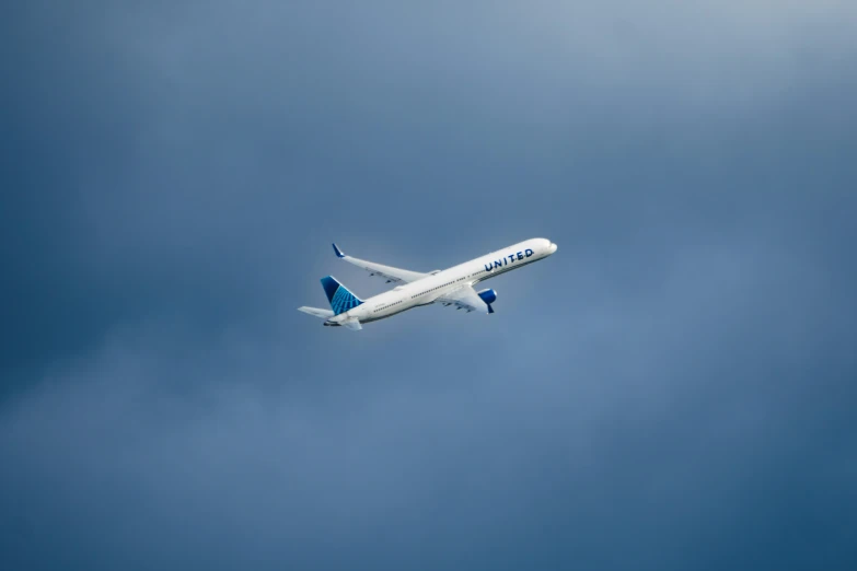 a jumbo jet plane flying against the blue sky